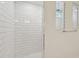 Modern shower with white subway tile and updated fixtures at 37194 Clinch Cir, Zephyrhills, FL 33540