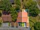 Aerial view of home with new roof surrounded by lush greenery and mature trees at 4016 Lighthouse Way, New Port Richey, FL 34652