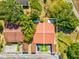 Aerial view of a home with a red roof, outlined in white, showing its proximity to the neighborhood at 4016 Lighthouse Way, New Port Richey, FL 34652