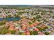 Aerial view showcases the community's layout and access to the lakes with the Gulf of Mexico in the background at 4016 Lighthouse Way, New Port Richey, FL 34652