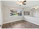 Neutral bedroom with wood floors, a ceiling fan, and a window that gives lots of natural light at 4016 Lighthouse Way, New Port Richey, FL 34652