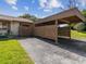 Home featuring attached carport and long driveway surrounded by a lush green lawn at 4016 Lighthouse Way, New Port Richey, FL 34652