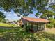 Lawn view of home featuring glass sunroom and a well-maintained front lawn at 4016 Lighthouse Way, New Port Richey, FL 34652