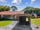 Charming house featuring a carport with an American flag and a well-maintained lawn at 4016 Lighthouse Way, New Port Richey, FL 34652