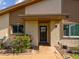 Close-up of front entrance with black door, and adjacent window, framed by well-kept landscaping at 4016 Lighthouse Way, New Port Richey, FL 34652