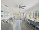 Bright and airy living room with wood-look floors, modern furniture, and views of the outdoors at 4016 Lighthouse Way, New Port Richey, FL 34652