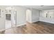 Open-concept living space with wood-look floors and arched doorways leading to other rooms at 4016 Lighthouse Way, New Port Richey, FL 34652
