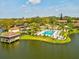 Community pool and hot tub with lush landscaping overlooking the lake create a resort-like atmosphere at 4016 Lighthouse Way, New Port Richey, FL 34652