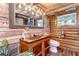 Bathroom featuring wooden walls, bright lighting, and a hammered copper sink at 4126 Burrows Rd, Zephyrhills, FL 33542