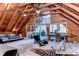 Large bedroom with vaulted ceilings, wood beams, a bed, a desk, and a sliding glass door at 4126 Burrows Rd, Zephyrhills, FL 33542