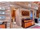 Rustic log cabin bedroom with a dresser, closet, and cozy carpet at 4126 Burrows Rd, Zephyrhills, FL 33542