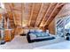 Bedroom featuring vaulted ceiling, wood beams, bed, dresser, and view to the outdoor at 4126 Burrows Rd, Zephyrhills, FL 33542