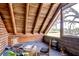 Cozy bonus room with sloped wood ceiling, classic furnishings, and picturesque outdoor views at 4126 Burrows Rd, Zephyrhills, FL 33542