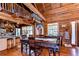Cozy dining area with rustic touches, log walls, a painting and an open view to the kitchen area at 4126 Burrows Rd, Zephyrhills, FL 33542