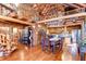 Charming dining room with rustic wood finishes, wooden staircase and exposed log beams for a cozy, inviting atmosphere at 4126 Burrows Rd, Zephyrhills, FL 33542