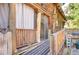 Exterior of the home featuring a ramp leading to the log-cabin siding and rustic wood accents at 4126 Burrows Rd, Zephyrhills, FL 33542