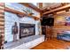 Close-up of a stone fireplace with a wooden mantel and decorative accents at 4126 Burrows Rd, Zephyrhills, FL 33542