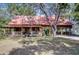 Charming log home with a metal roof, covered porch, and attached carport at 4126 Burrows Rd, Zephyrhills, FL 33542