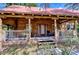 Charming log home featuring a cozy front porch with a rocking chair and a beautifully designed facade at 4126 Burrows Rd, Zephyrhills, FL 33542