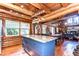 Open kitchen and dining area featuring marble island, wood cabinets, and views of the fireplace at 4126 Burrows Rd, Zephyrhills, FL 33542