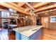 Open kitchen with marble island, stainless appliances, and view of the staircase and dining room at 4126 Burrows Rd, Zephyrhills, FL 33542