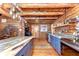 Charming log cabin kitchen with custom cabinets, marble countertop, and wood flooring at 4126 Burrows Rd, Zephyrhills, FL 33542