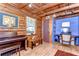 Log cabin-style living room featuring natural light, wood floors, and access to a small office at 4126 Burrows Rd, Zephyrhills, FL 33542
