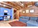 Cozy living room features wooden walls and a blue accent wall and work area at 4126 Burrows Rd, Zephyrhills, FL 33542