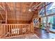 Upper level loft features wooden walls and a ceiling fan at 4126 Burrows Rd, Zephyrhills, FL 33542
