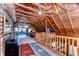 Wide angle shot of loft with exposed beams and wooden walls at 4126 Burrows Rd, Zephyrhills, FL 33542
