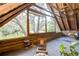Bright sunroom with vaulted wood ceiling, large windows, and comfortable seating with scenic views at 4126 Burrows Rd, Zephyrhills, FL 33542