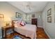 Comfortable bedroom features wood floors, ceiling fan, and natural light at 420 Poinsettia Rd, Belleair, FL 33756