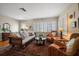 Cozy living room features a wicker sofa, armchairs, decorative rug, and plenty of natural light at 420 Poinsettia Rd, Belleair, FL 33756