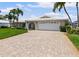 Charming single-story home featuring a large driveway, lush landscaping, and an attached two-car garage at 4333 48Th S Ave, St Petersburg, FL 33711