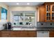 Bright kitchen featuring a window over the sink showcasing waterfront views, granite counters, and wooden cabinets at 4333 48Th S Ave, St Petersburg, FL 33711