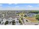 Aerial view of a neighborhood with well-maintained townhomes and landscaped streets under a bright sky at 4550 Globe Thistle Dr, Tampa, FL 33619