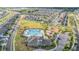 Aerial view of the community featuring a pool, playground, lush green spaces, and neatly arranged homes at 4550 Globe Thistle Dr, Tampa, FL 33619