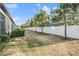 Wide backyard featuring a white fence and well trimmed bushes at 4550 Globe Thistle Dr, Tampa, FL 33619