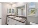 Stylish bathroom with a double sink vanity, granite countertop, and a large mirror at 4550 Globe Thistle Dr, Tampa, FL 33619