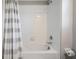 Bathroom with shower/tub combo featuring white tiled surround at 4550 Globe Thistle Dr, Tampa, FL 33619