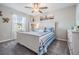 Comfortable bedroom with a large window, ceiling fan, and neutral decor at 4550 Globe Thistle Dr, Tampa, FL 33619