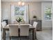 Bright dining room featuring a stylish chandelier, modern decor, and plenty of natural light at 4550 Globe Thistle Dr, Tampa, FL 33619
