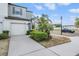 Attractive townhome featuring a two-car garage, lush landscaping, and a well-maintained exterior at 4550 Globe Thistle Dr, Tampa, FL 33619