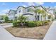 Beautiful exterior of a modern townhome, featuring lush landscaping and a two car garage at 4550 Globe Thistle Dr, Tampa, FL 33619