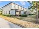 A row of townhomes with screened patios, neat landscaping, and well-maintained exteriors at 4550 Globe Thistle Dr, Tampa, FL 33619