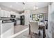 Well-lit kitchen with white cabinets, black appliances, and an adjacent dining area at 4550 Globe Thistle Dr, Tampa, FL 33619