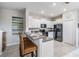 Bright eat-in kitchen featuring white cabinets, granite counters, black appliances, and a cozy breakfast bar at 4550 Globe Thistle Dr, Tampa, FL 33619