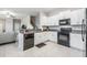 Open kitchen with modern appliances, granite countertops, and ample cabinet space at 4550 Globe Thistle Dr, Tampa, FL 33619