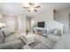 Spacious living room with neutral decor, tile floors, and a cozy fireplace feature at 4550 Globe Thistle Dr, Tampa, FL 33619