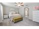 Serene main bedroom with a ceiling fan, plush carpeting, and an en-suite bathroom entrance at 4550 Globe Thistle Dr, Tampa, FL 33619